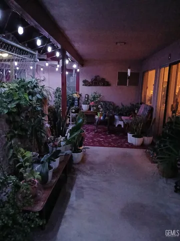 a view of a room with lots of potted plants and a table