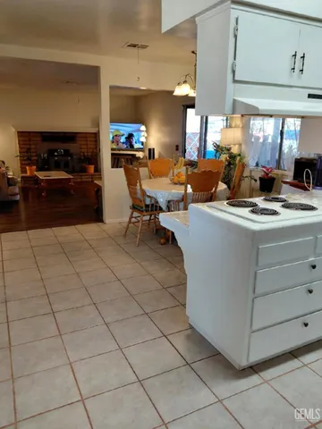 a open kitchen with stainless steel appliances kitchen island granite countertop a sink and cabinets