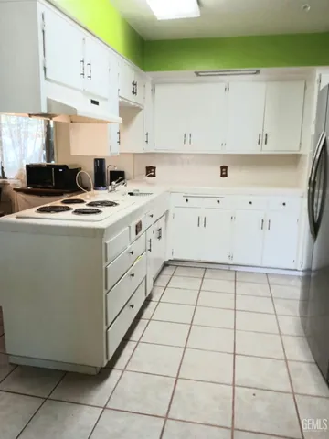 a kitchen with cabinets and a stove