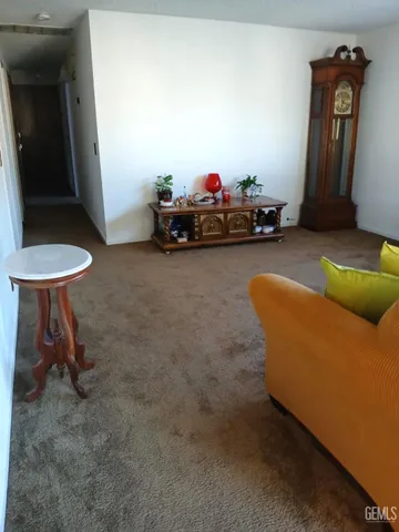 a living room with furniture and a mirror