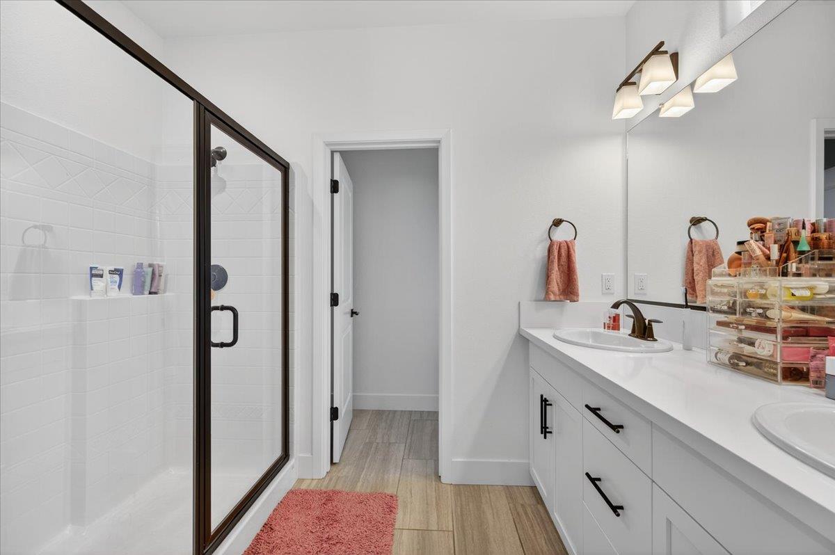 4593 Orchard Hills Road Madera, CA 93636 - Photo 18 of 25 a bathroom with a sink and a mirror