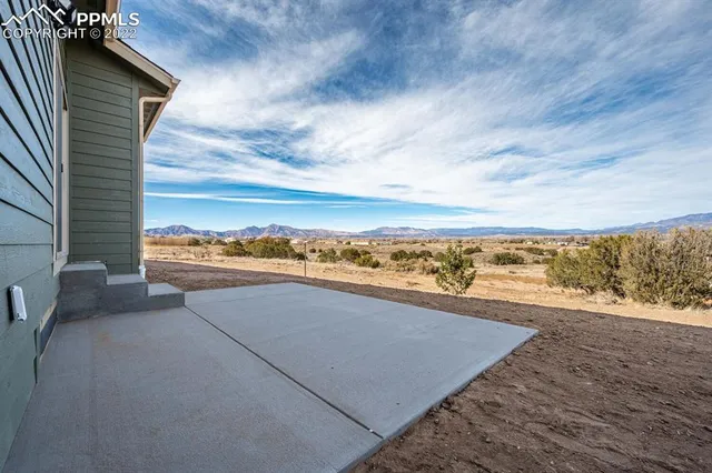 a view of a kitchen with granite countertop stainless steel appliances and wooden floor