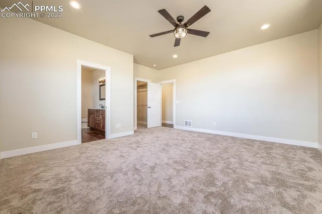 a bathroom with a granite countertop sink a toilet and a mirror