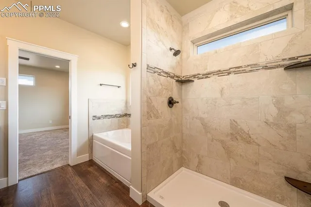 a bathroom with a granite countertop sink vanity and mirror