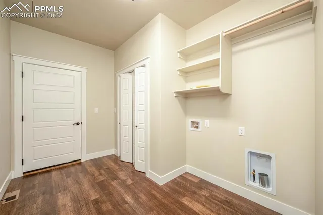 a view of a room with wooden floor