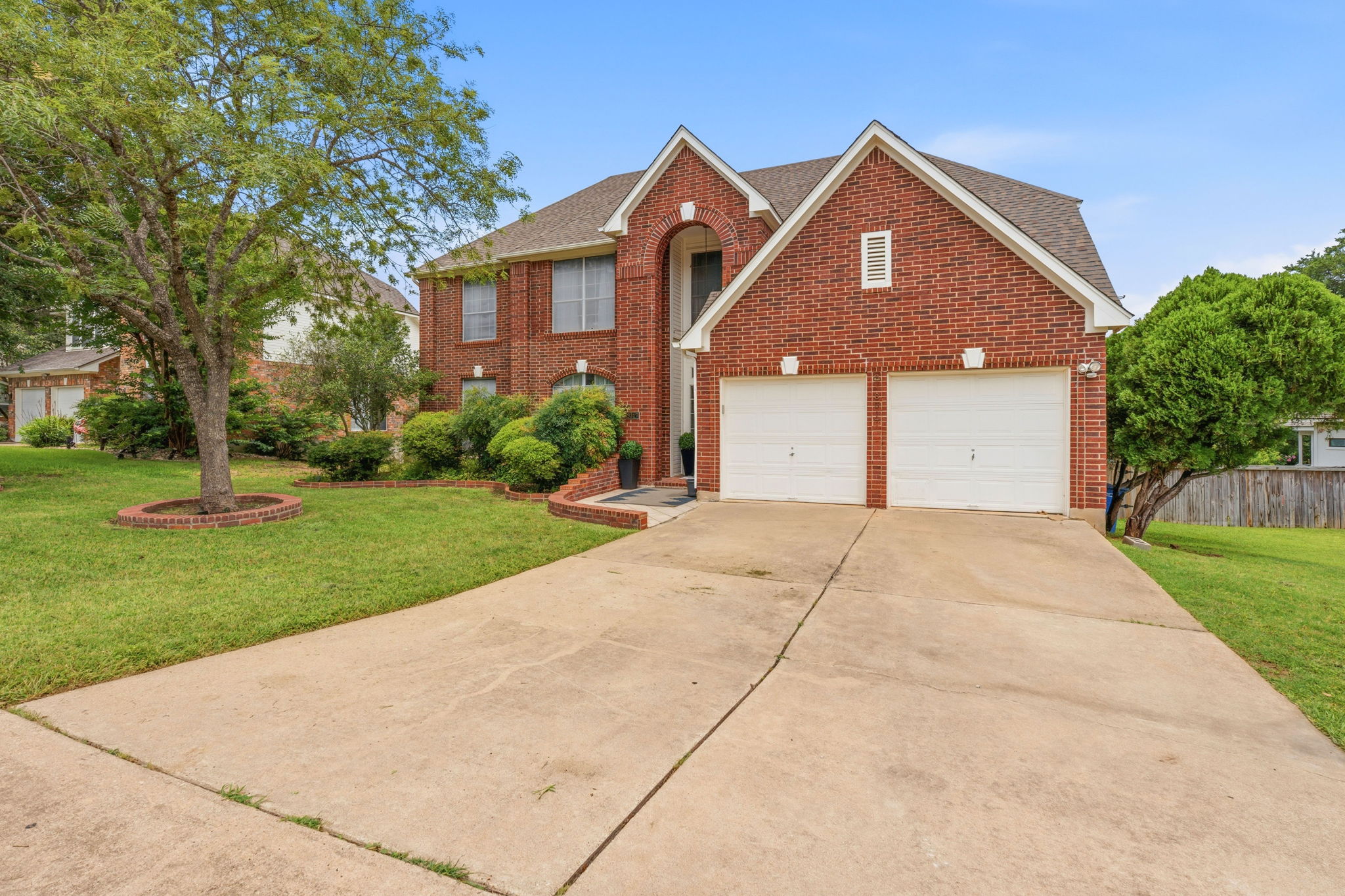 8317 Pommel Drive Austin, TX 78759 - Photo 1 of 26 A classic brick facade welcomes guests with an inviting arched entry and dual garage doors.