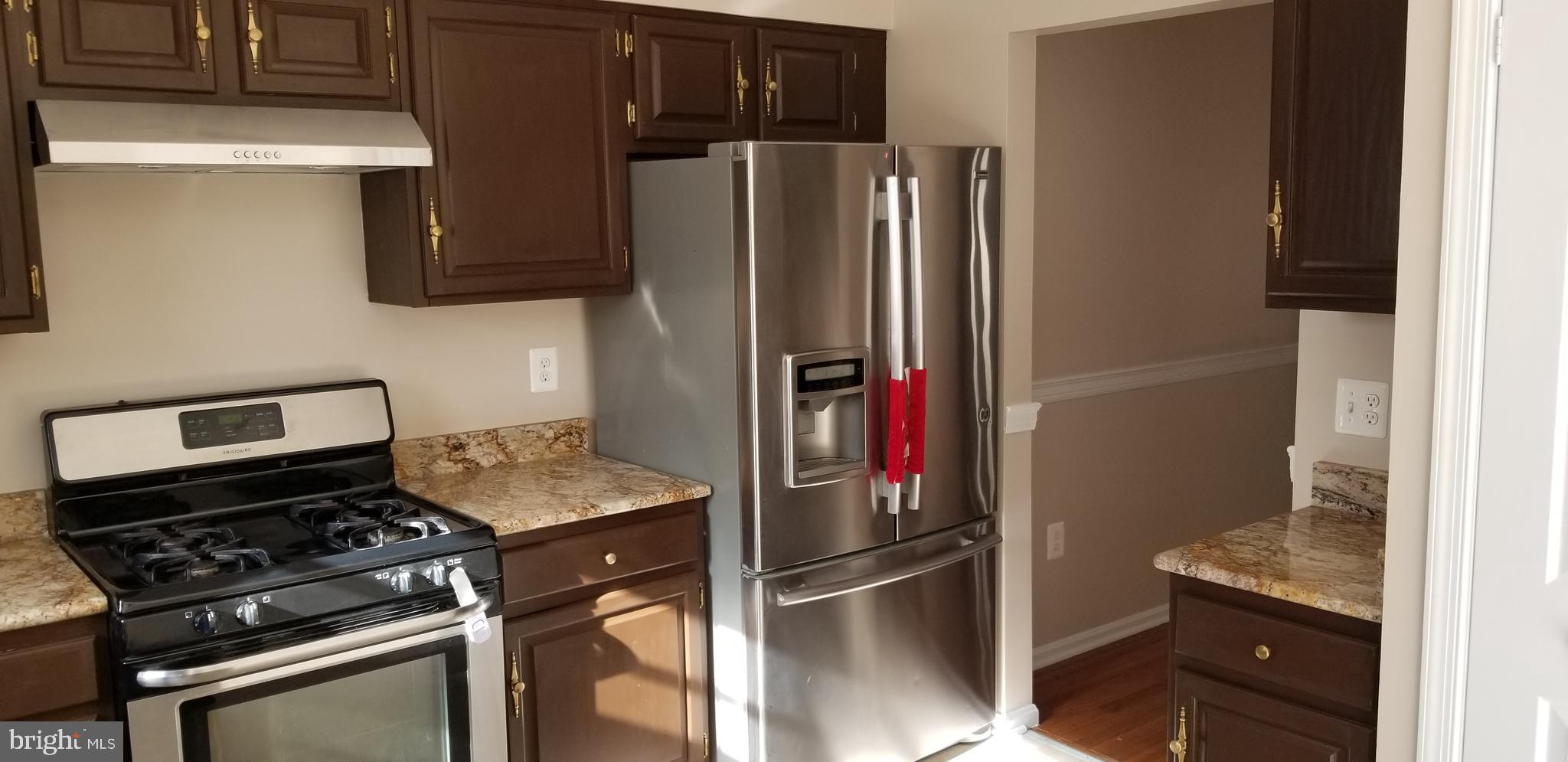 7728 Gromwell Court Springfield, VA 22152 - Photo 5 of 16 Granite Kitchen with stainless suite of appliances