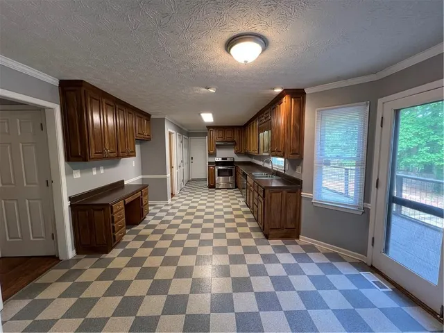 a view of empty room with wooden floor and fireplace
