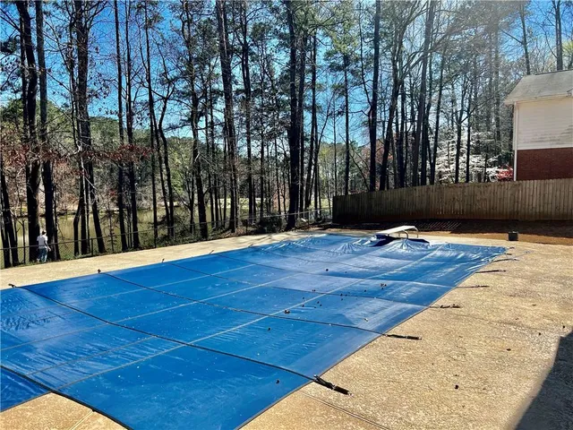 an aerial view of a house with outdoor space and swimming pool