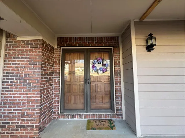 a view of a room with wooden floors and fan