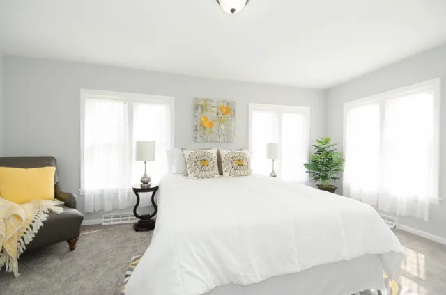 a spacious bedroom with a bed and window