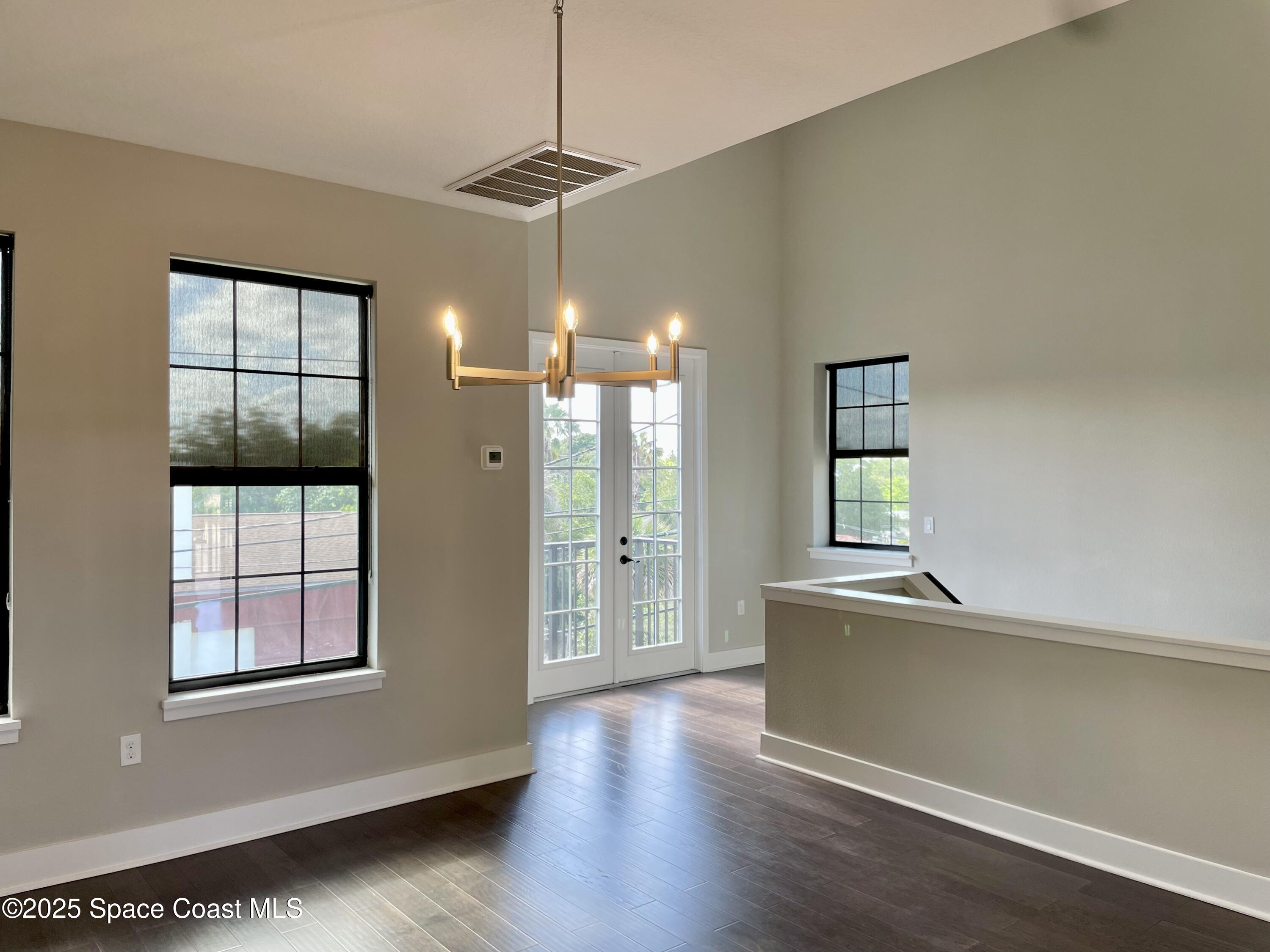 890 Florida Avenue Cocoa, FL 32922 - Photo 13 of 63 a view of an empty room with window and wooden floor