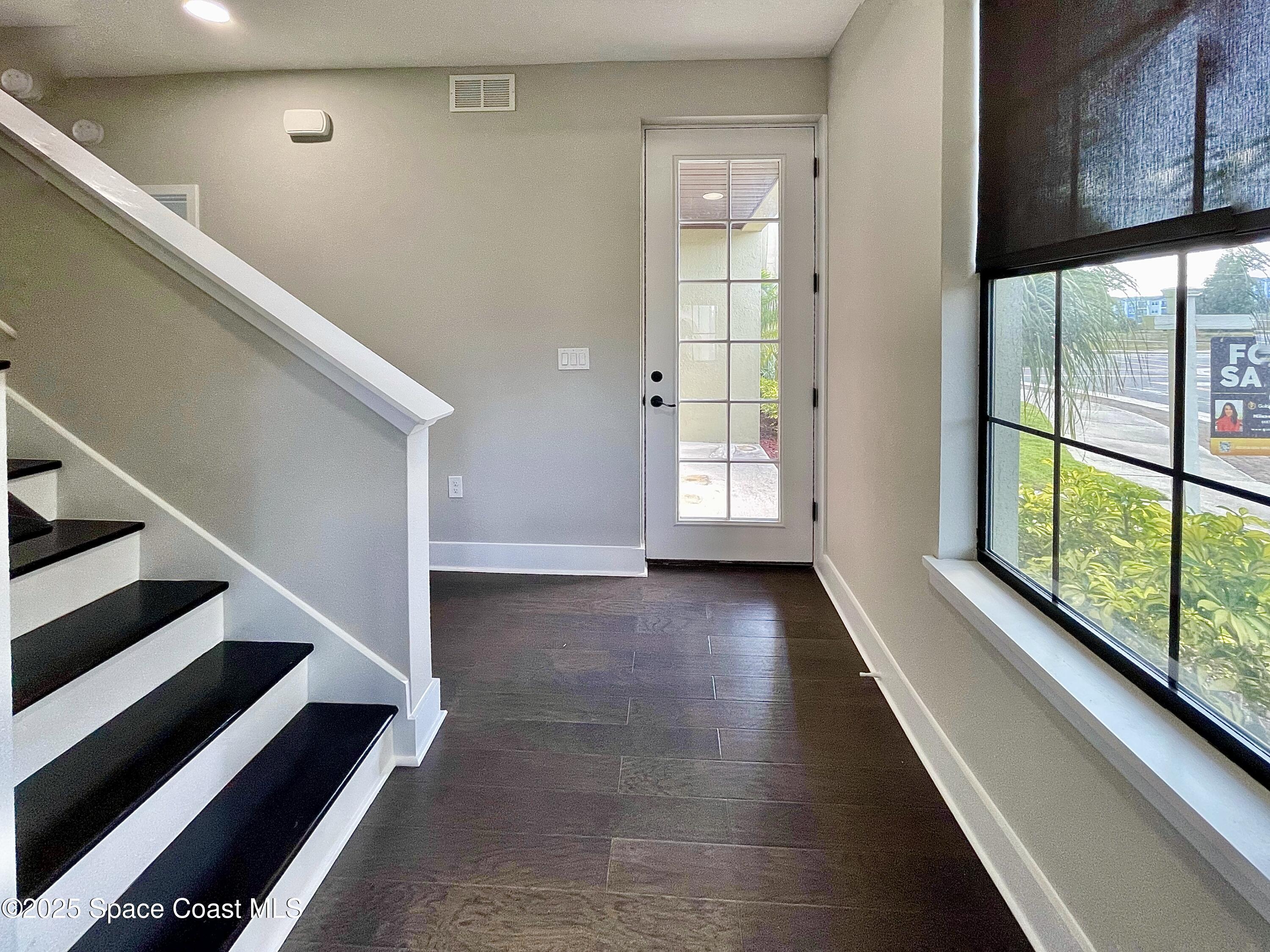 890 Florida Avenue Cocoa, FL 32922 - Photo 24 of 63 a view of entryway with wooden floor and stairs