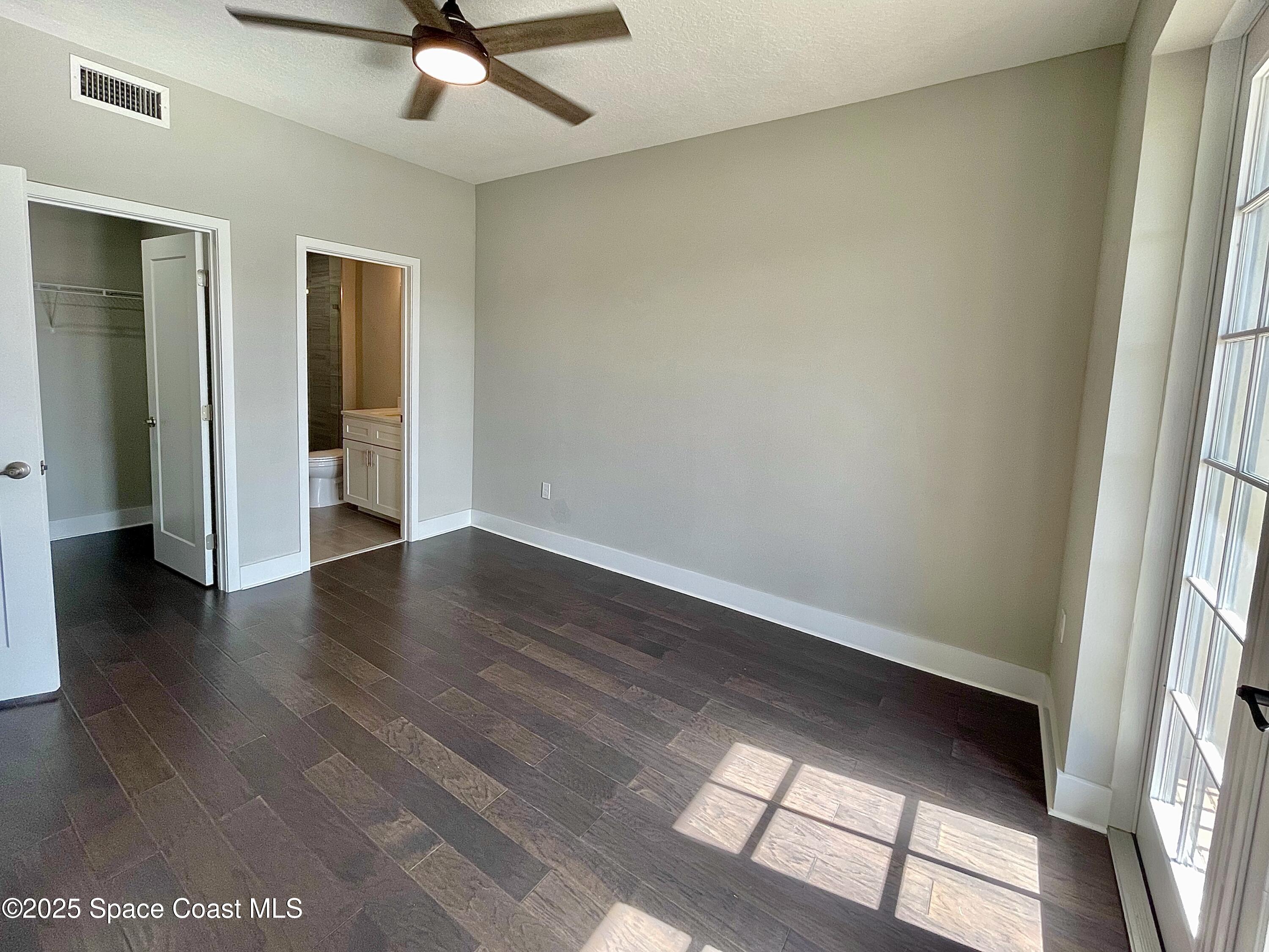 890 Florida Avenue Cocoa, FL 32922 - Photo 31 of 63 a view of an empty room with wooden floor and a window