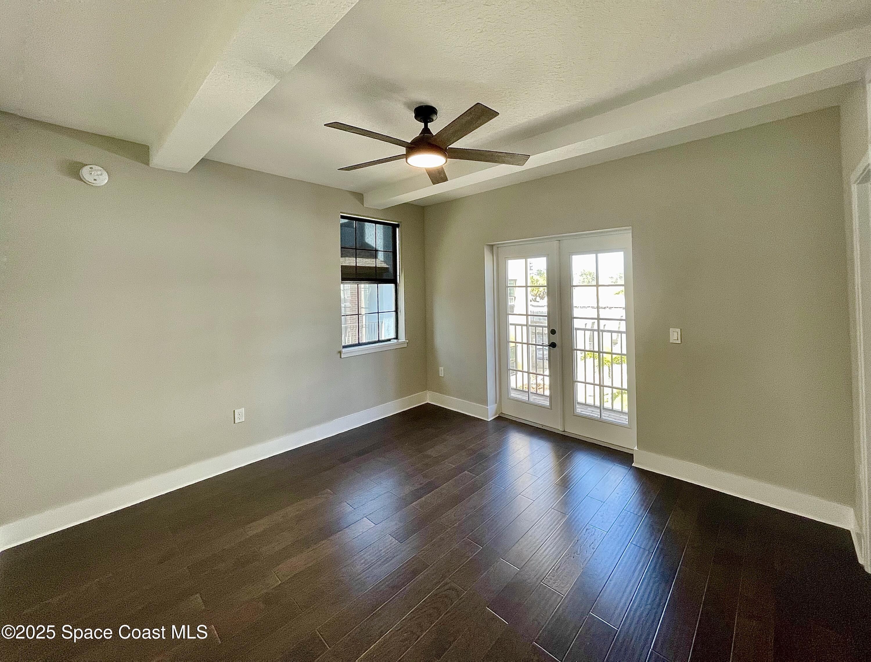 890 Florida Avenue Cocoa, FL 32922 - Photo 39 of 63 an empty room with wooden floor fan and windows