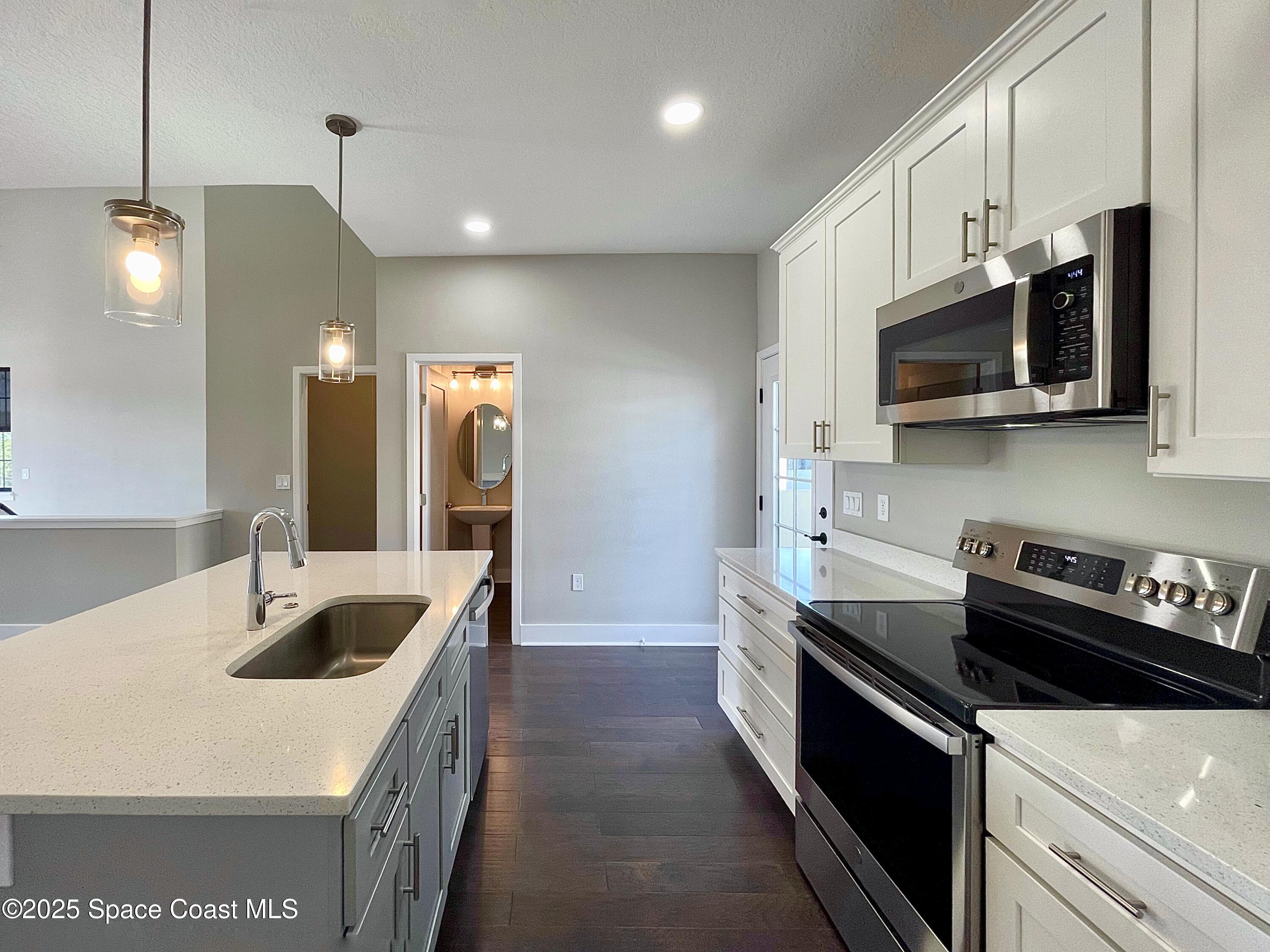 890 Florida Avenue Cocoa, FL 32922 - Photo 43 of 63 a kitchen that has a sink and a stove