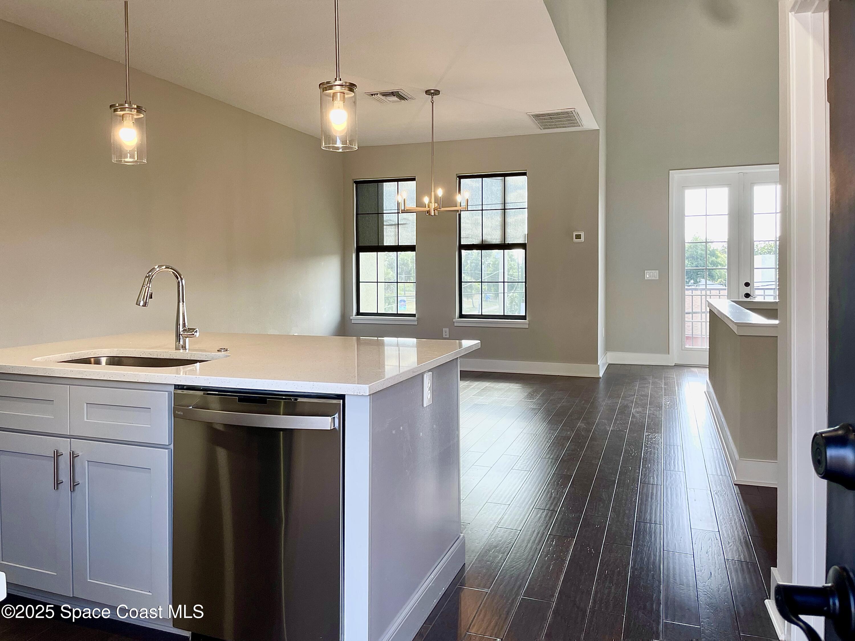890 Florida Avenue Cocoa, FL 32922 - Photo 46 of 63 a view of a kitchen with a sink and dishwasher with wooden floor