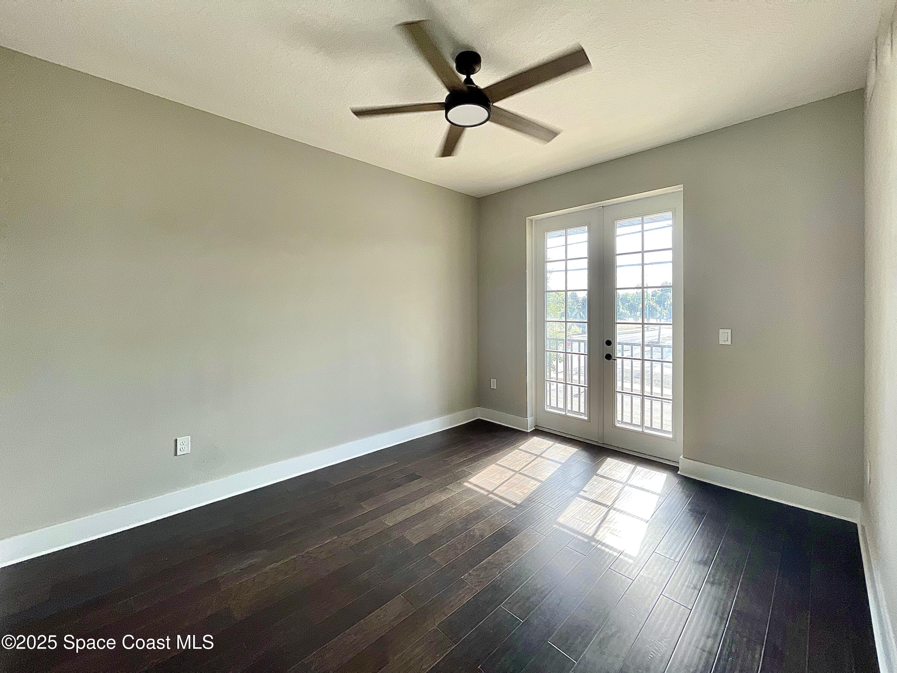 890 Florida Avenue Cocoa, FL 32922 - Photo 49 of 63 an empty room with wooden floor and windows