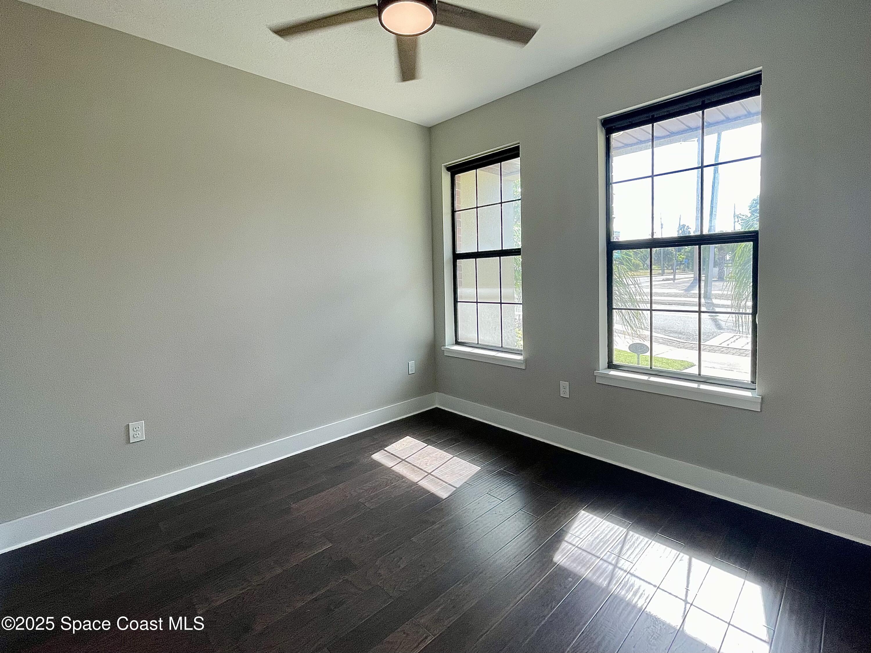890 Florida Avenue Cocoa, FL 32922 - Photo 10 of 63 an empty room with wooden floor and windows