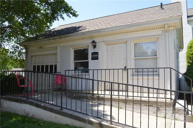 a view of a house with a wooden fence