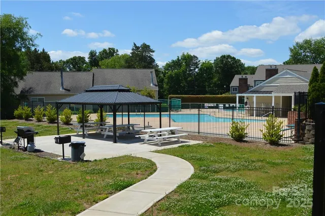 a view of a house with backyard sitting area and garden