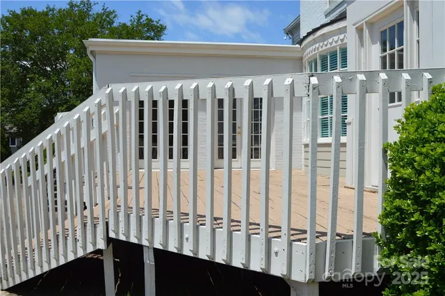 a view of a balcony with wooden fence