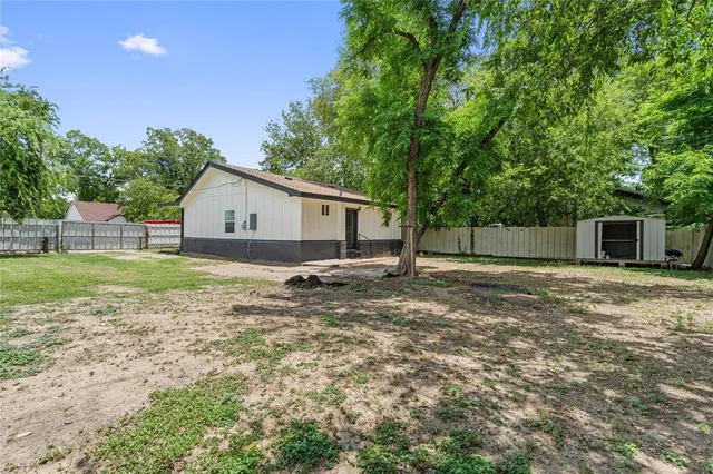 a view of a house with a yard and sitting area