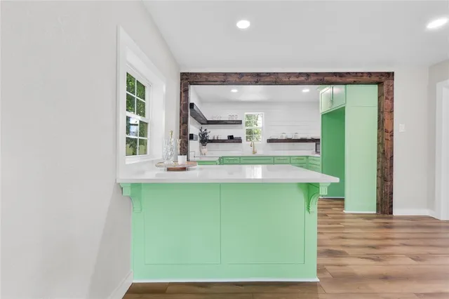 a kitchen with a sink and large windows