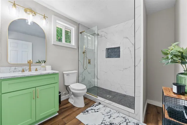 a bathroom with a toilet sink and shower