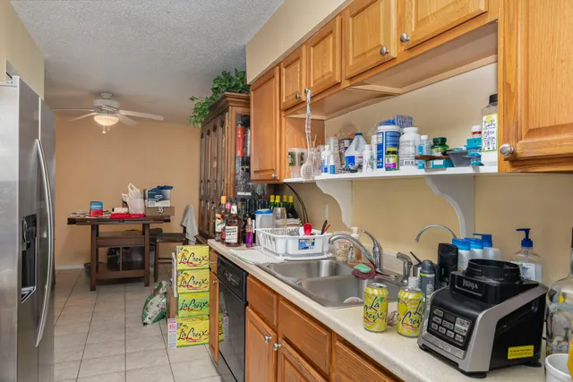 a kitchen with a sink and a stove next to a window