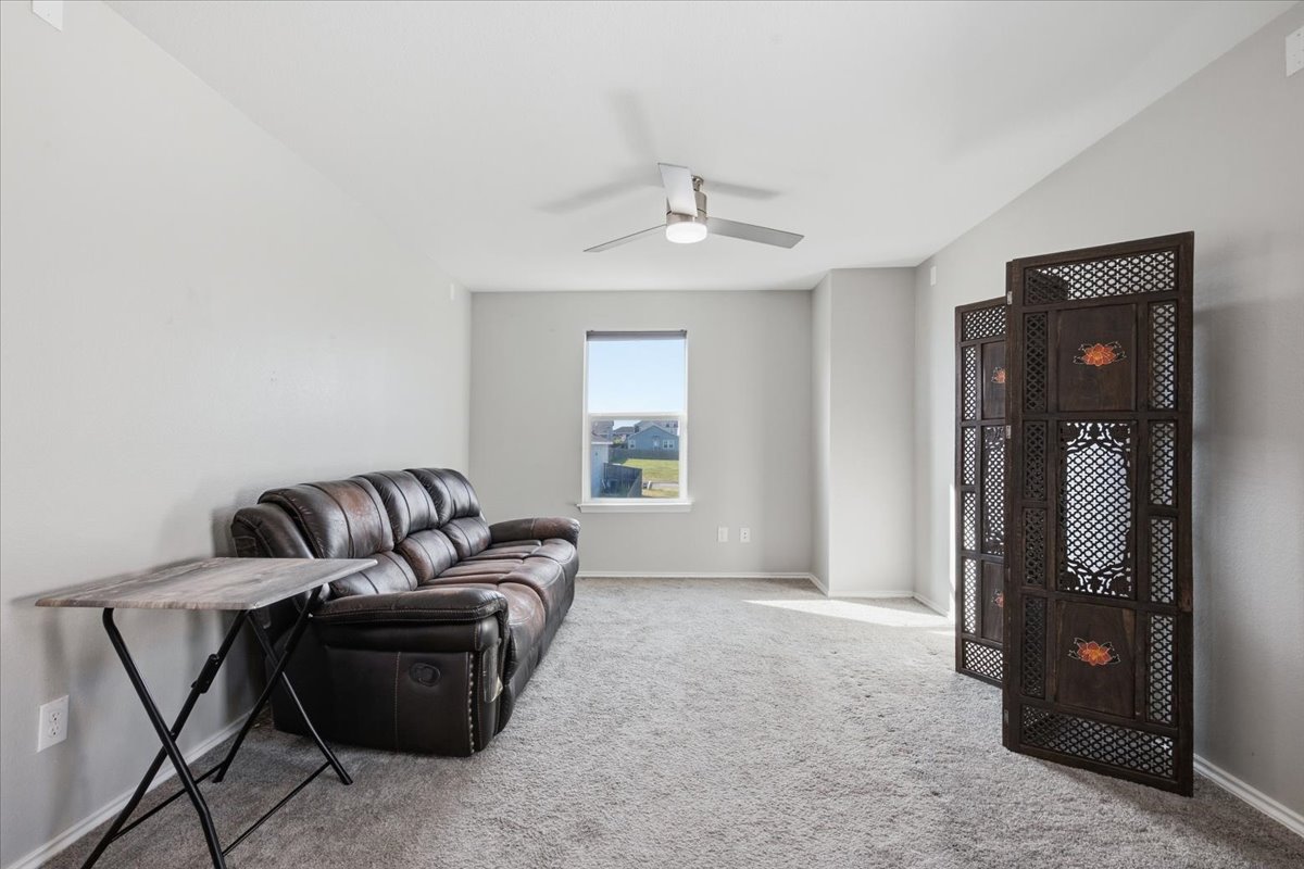 104 Rooster Way Jarrell, TX 76537 - Photo 14 of 33 A single window provides natural light to this carpeted living area.