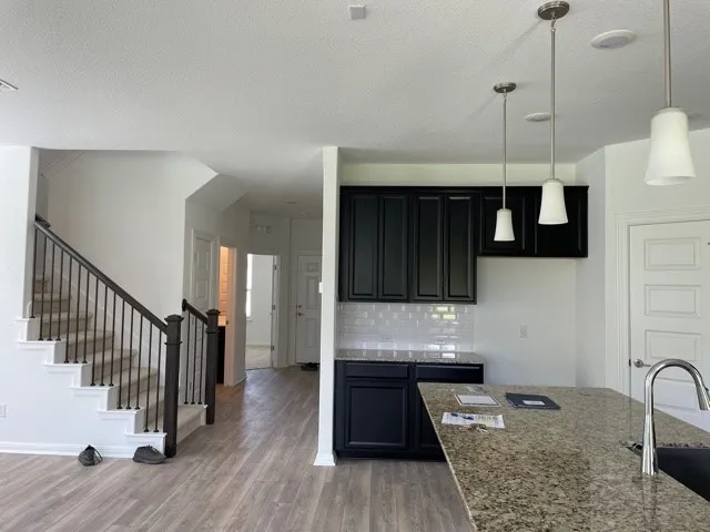 a kitchen with granite countertop stainless steel appliances and wooden cabinets