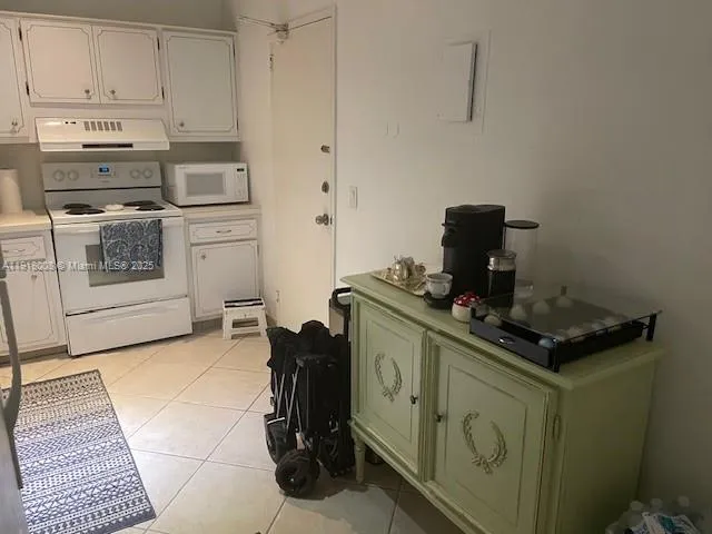 a kitchen with a stove and a microwave