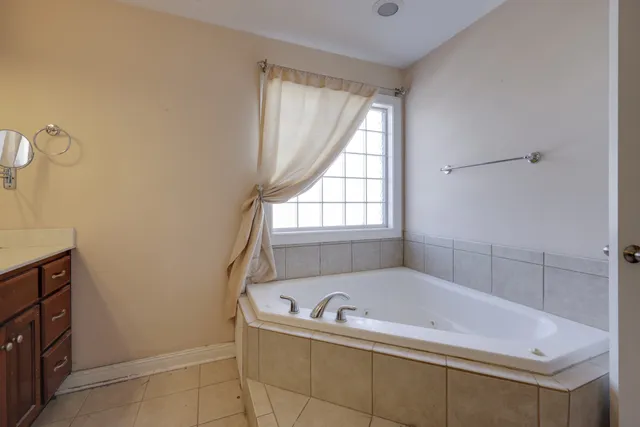 a bath tub sitting in a bathroom next to a window