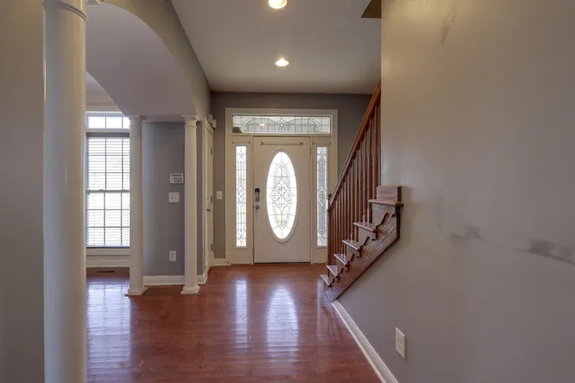 a view of an entryway with wooden floor