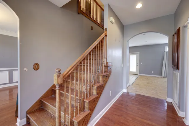a view of entryway with wooden floor and stairs