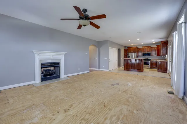 an empty room with furniture and a ceiling fan
