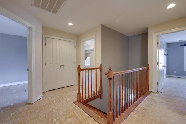 a view of a hallway with entryway door door and stairs