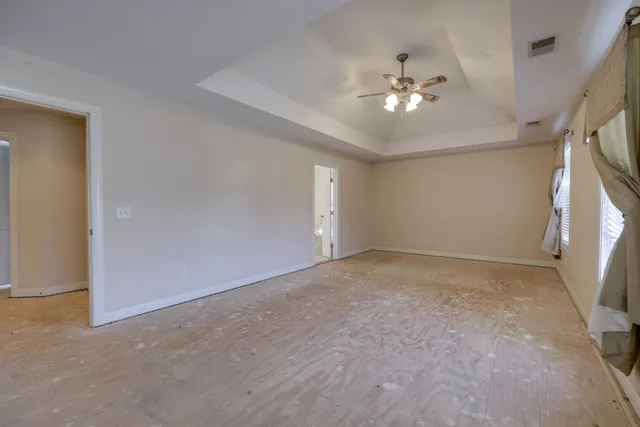 a view of a livingroom with a ceiling fan and window