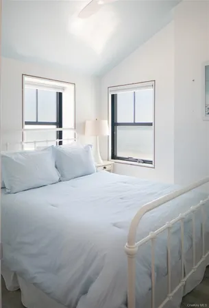 a bedroom with a large bed and a window