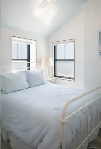 a bedroom with a large bed and a window