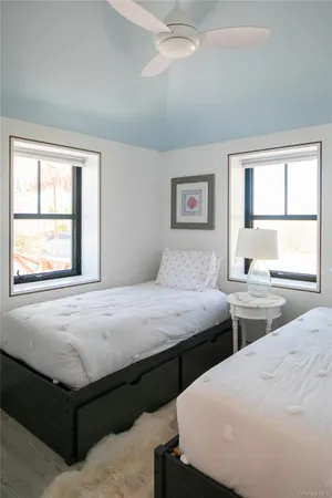 a bedroom with two beds and a window