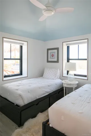 a bedroom with two beds and a window