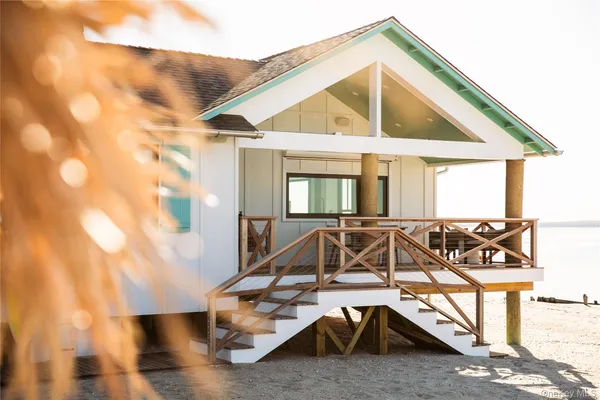 a view of a house with wooden deck