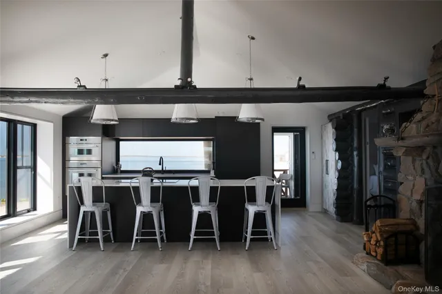 a large kitchen with a table and chairs