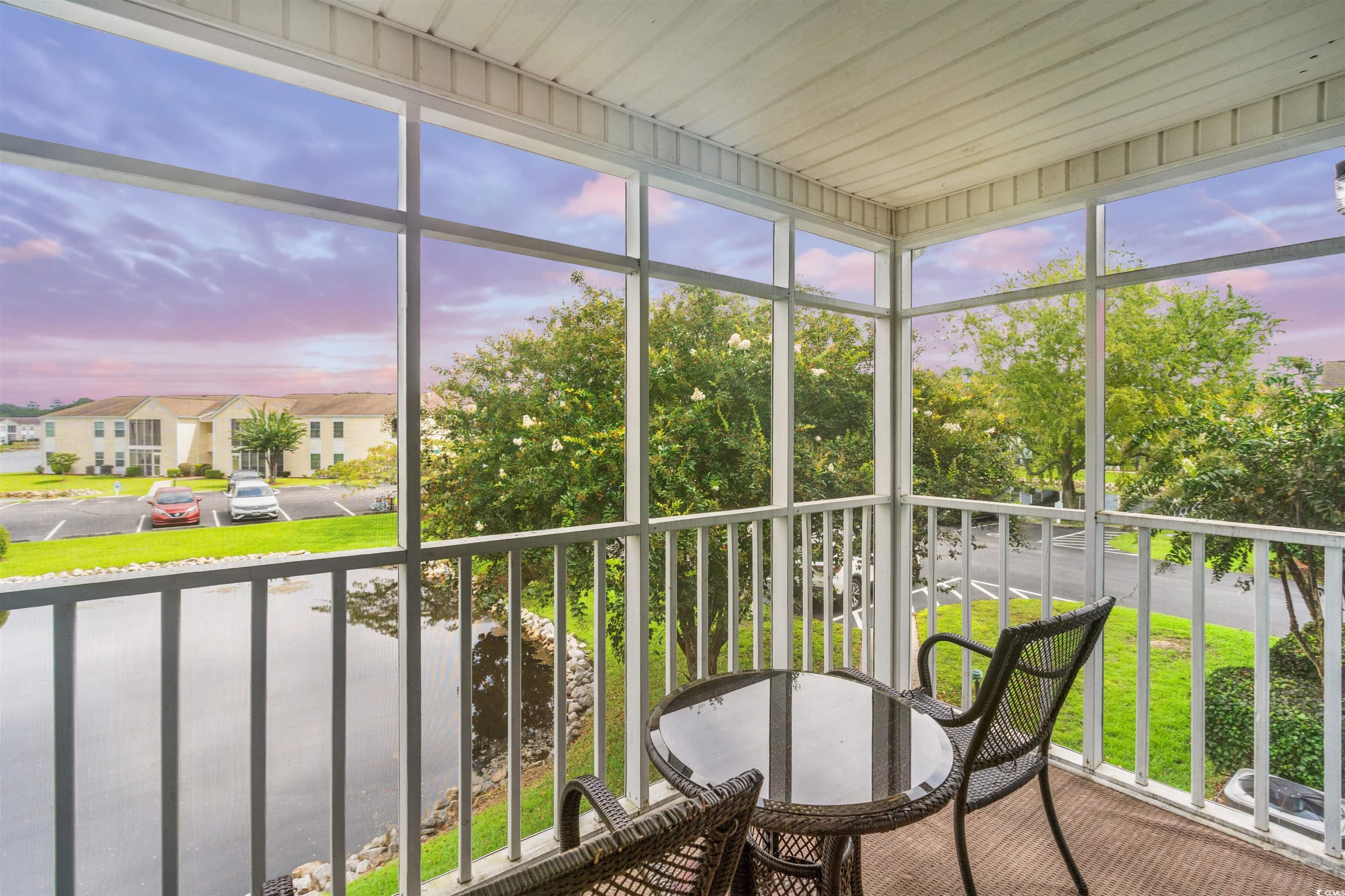 8862 Duckview Drive, Unit E Surfside Beach, SC 29575 - Photo 6 of 16 Sunroom / solarium with healthy amount of natural light