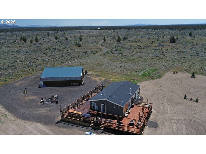 a aerial view of a house with a yard