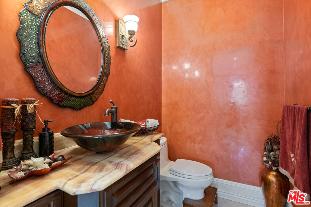 2023 Parnell Avenue Los Angeles, CA 90025 - Photo 19 of 59 a bathroom with a granite countertop toilet and a sink