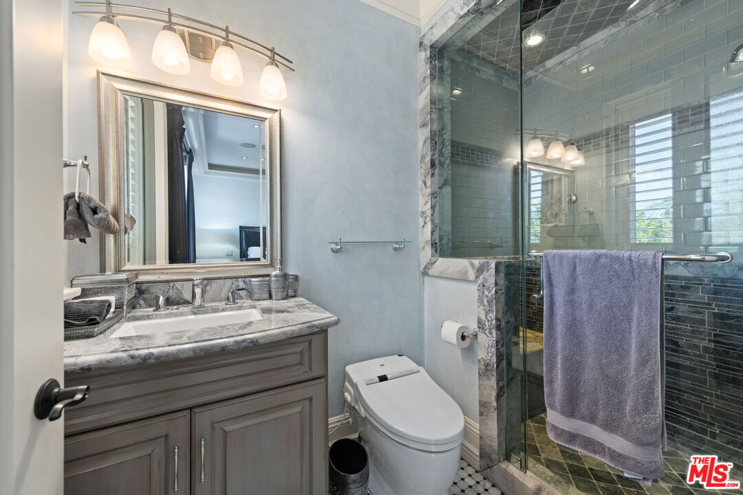 2023 Parnell Avenue Los Angeles, CA 90025 - Photo 26 of 59 a bathroom with a toilet a sink a mirror and a shower