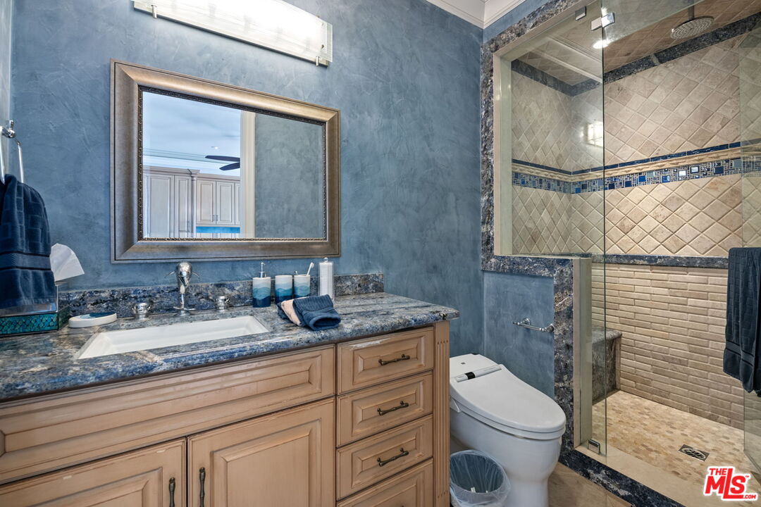 2023 Parnell Avenue Los Angeles, CA 90025 - Photo 32 of 59 a bathroom with a granite countertop sink mirror vanity and toilet